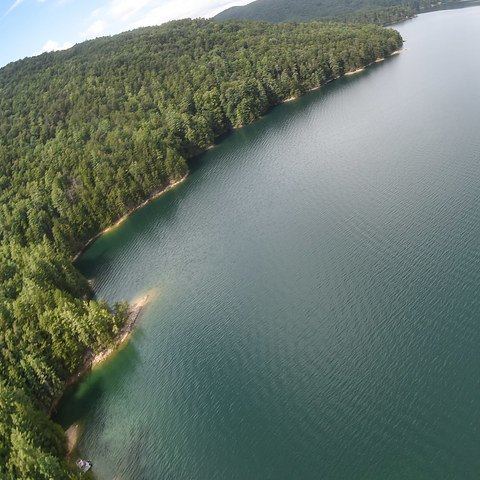 Lake Jocassee from above, green water between forested ridges.